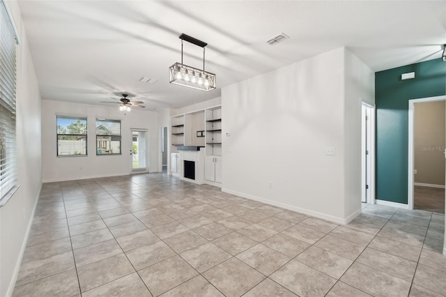 unfurnished living room with light tile patterned floors and ceiling fan