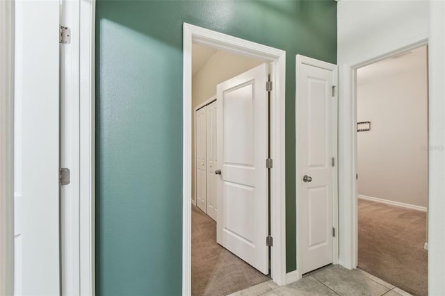 hall featuring light colored carpet