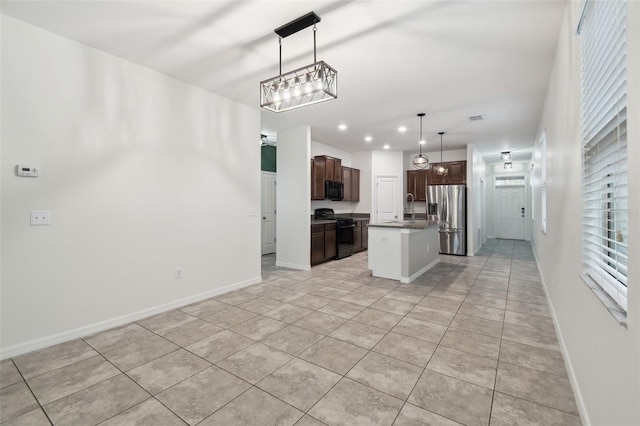 kitchen featuring a kitchen island with sink, decorative light fixtures, dark brown cabinets, and black appliances