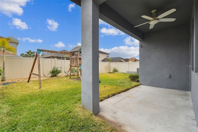 view of yard with a playground, ceiling fan, and a patio area