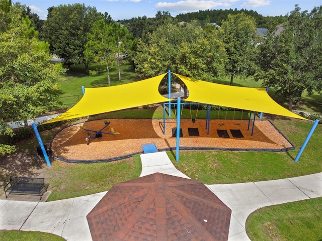 view of property's community featuring a lawn and a playground