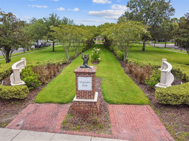 view of property's community with a lawn