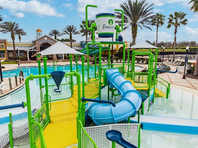 view of jungle gym with a community pool and a gazebo