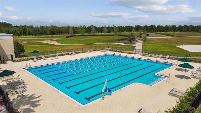 view of swimming pool with a yard and a patio area