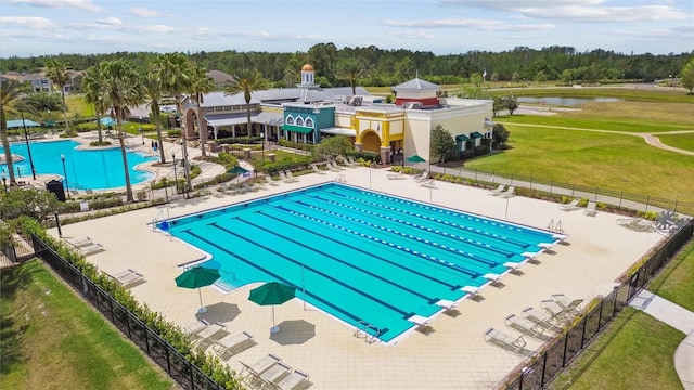 view of swimming pool with a patio area and a water view