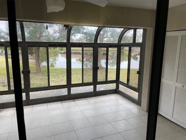 unfurnished sunroom featuring a healthy amount of sunlight and a water view