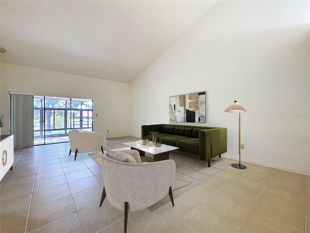 living area featuring high vaulted ceiling, a textured ceiling, baseboards, and light tile patterned floors