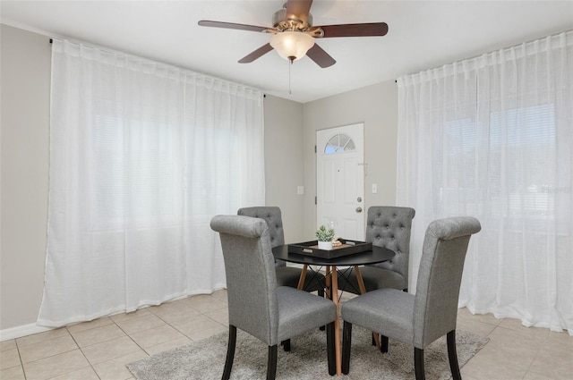 tiled dining area with ceiling fan