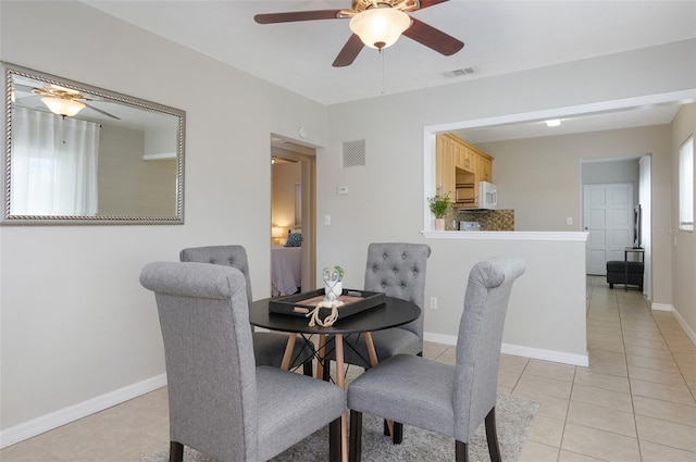 dining area with light tile patterned flooring and ceiling fan