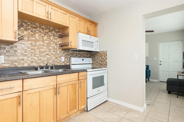 kitchen featuring light brown cabinetry, sink, tasteful backsplash, light tile patterned floors, and white appliances