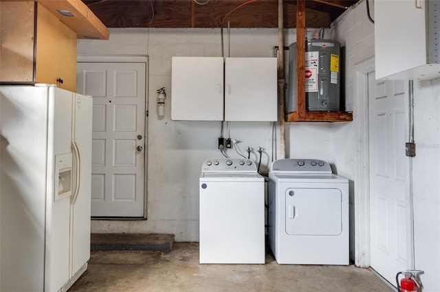 laundry room with cabinets, electric water heater, and independent washer and dryer