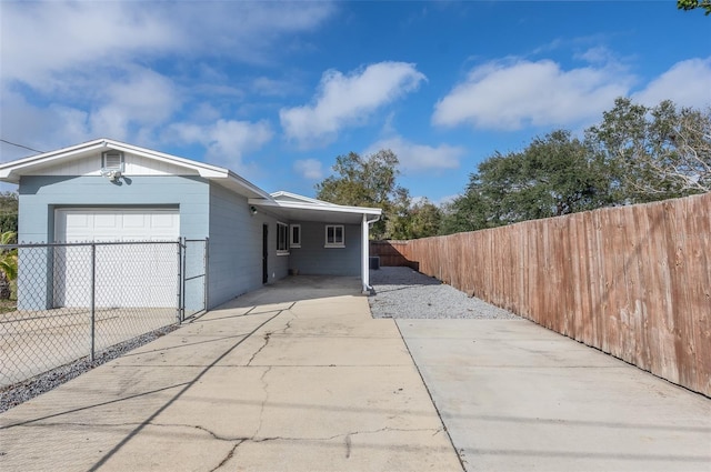 view of front of home with a carport and a garage