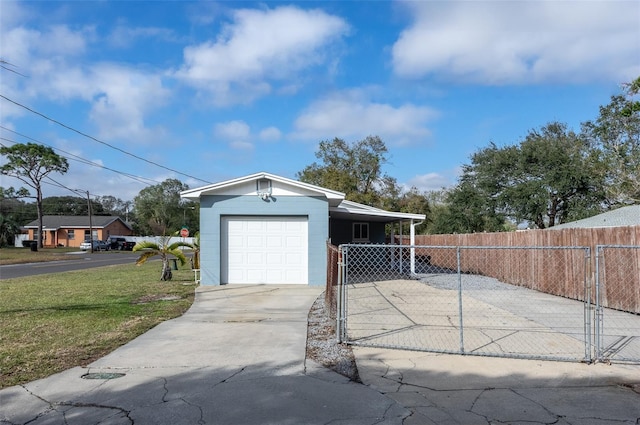 garage with a lawn and a carport