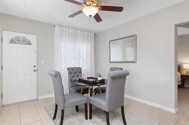 dining space featuring ceiling fan and light tile patterned floors