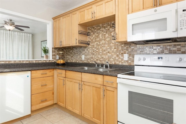 kitchen with light brown cabinetry, sink, light tile patterned floors, white appliances, and decorative backsplash