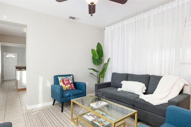 tiled living room featuring ceiling fan