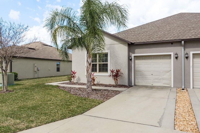 single story home featuring a garage, central AC, and a front lawn