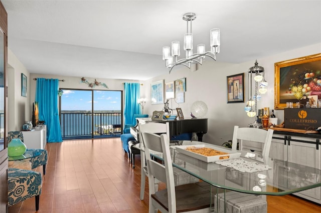 dining space with an inviting chandelier and wood-type flooring