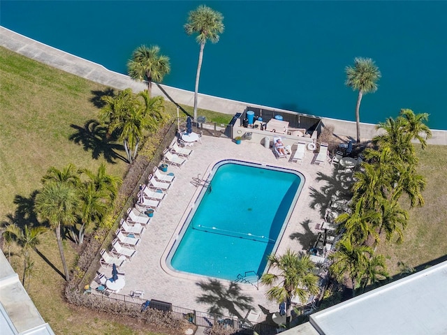 view of swimming pool featuring a water view and a patio