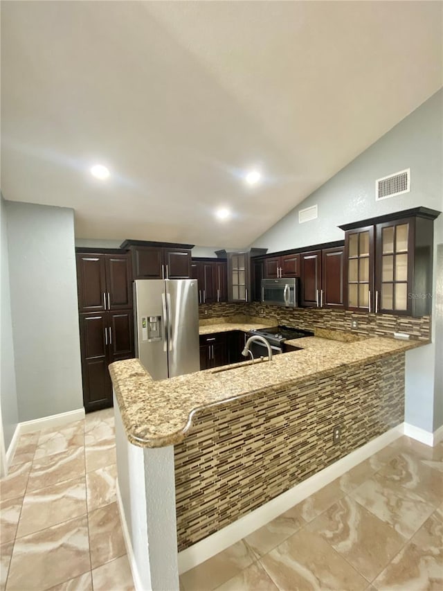 kitchen featuring stainless steel appliances, kitchen peninsula, sink, and dark brown cabinets