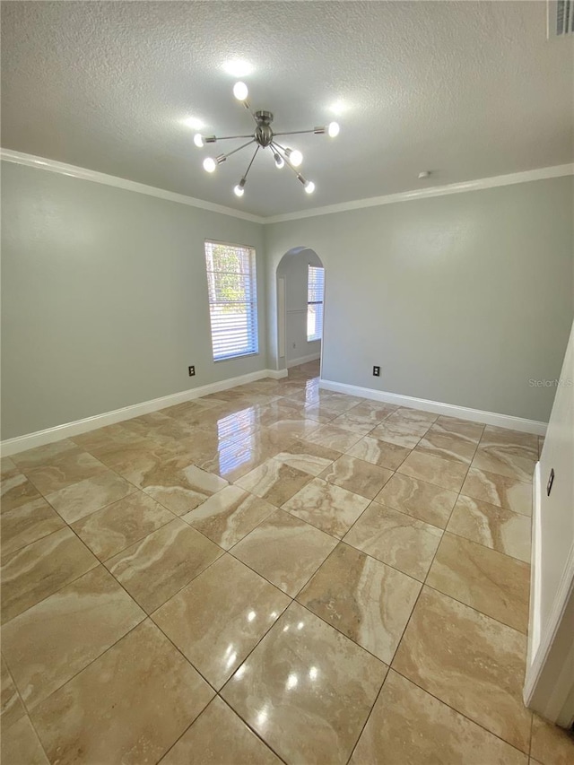 spare room featuring crown molding, a notable chandelier, and a textured ceiling