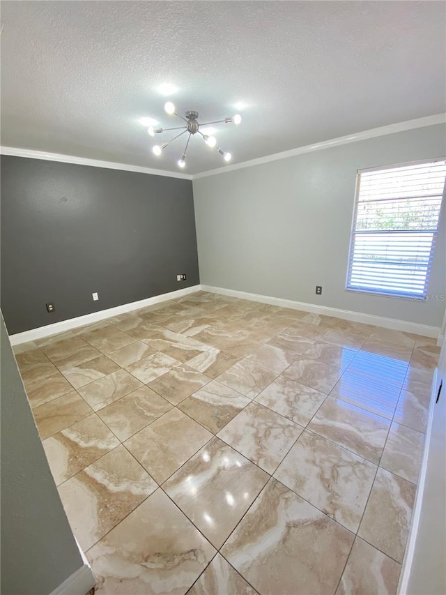 empty room featuring ornamental molding and a textured ceiling