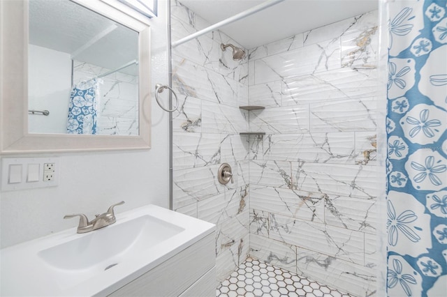 bathroom featuring vanity and curtained shower