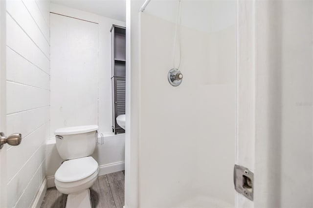 bathroom featuring hardwood / wood-style floors and toilet