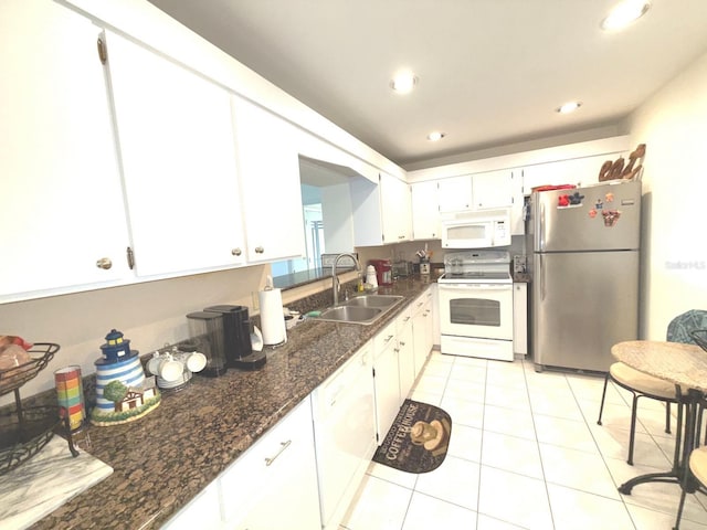 kitchen with white cabinetry, white appliances, sink, and dark stone countertops