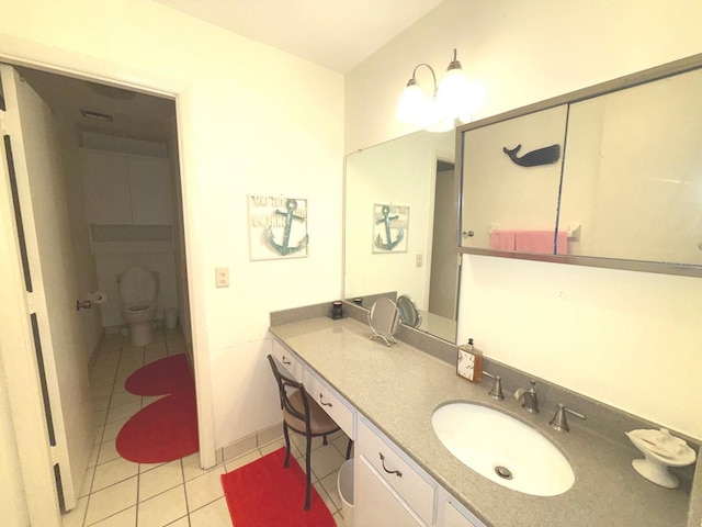 bathroom featuring vanity, tile patterned floors, and toilet