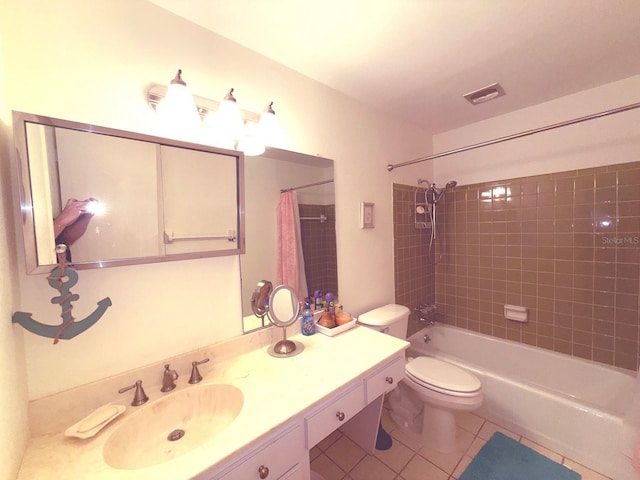 full bathroom with tile patterned floors, toilet, vanity, and shower / bath combo