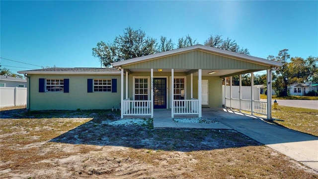 view of front of property with a carport and covered porch