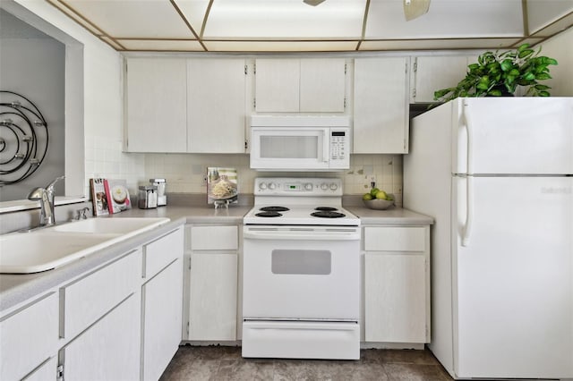 kitchen featuring sink, white appliances, and white cabinets