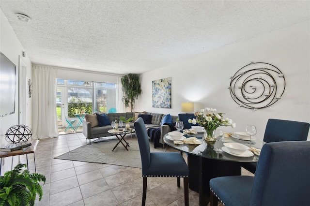 dining room featuring a textured ceiling and light tile patterned flooring