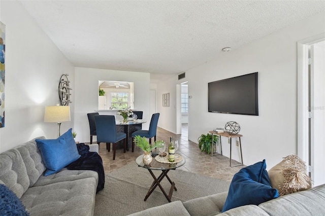 tiled living room with a textured ceiling