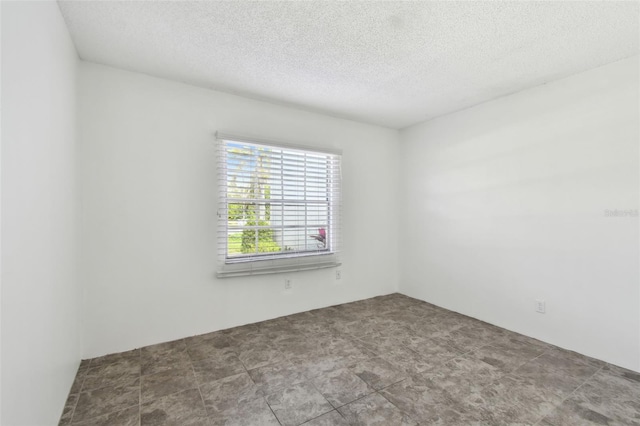 spare room with a textured ceiling