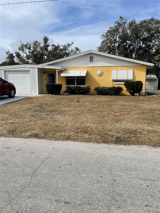 single story home with a garage and a front yard