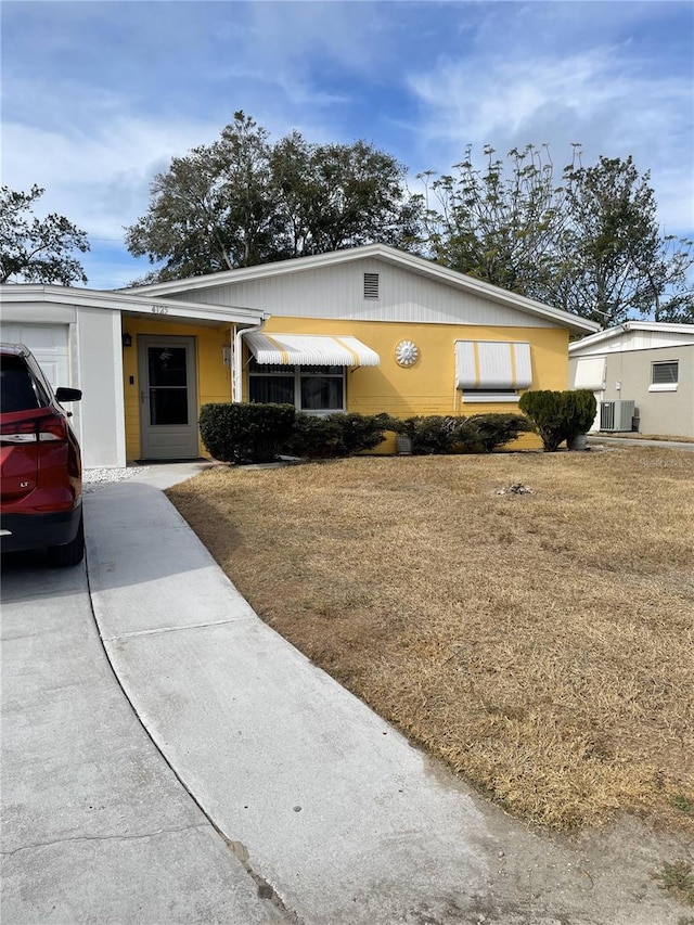 view of front of house featuring a front yard and central air condition unit