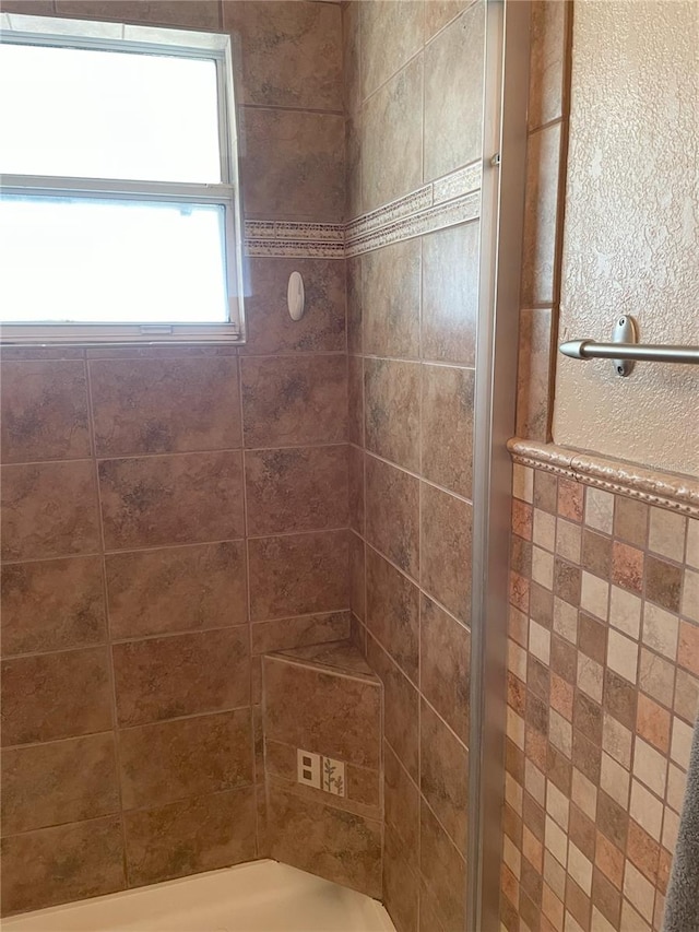 bathroom with a tile shower