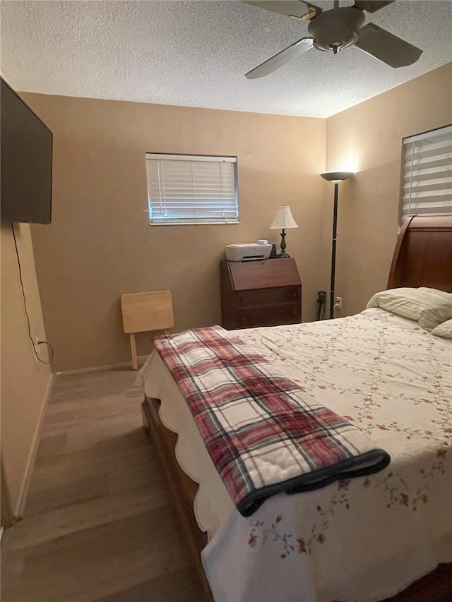 bedroom with ceiling fan and a textured ceiling