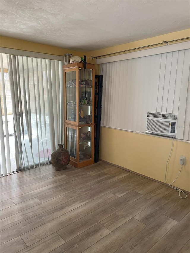 empty room featuring hardwood / wood-style flooring and cooling unit