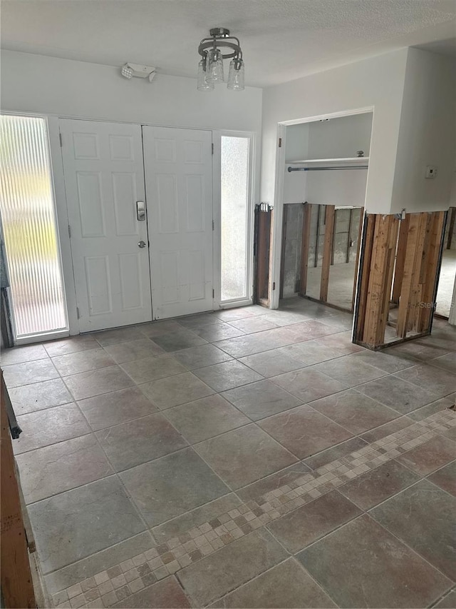 foyer with plenty of natural light and a notable chandelier