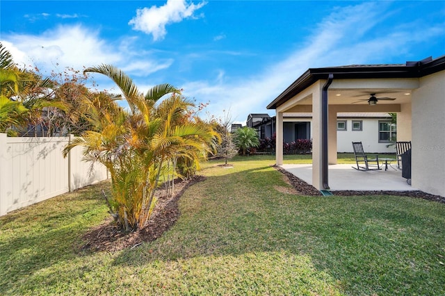 view of yard featuring ceiling fan and a patio area