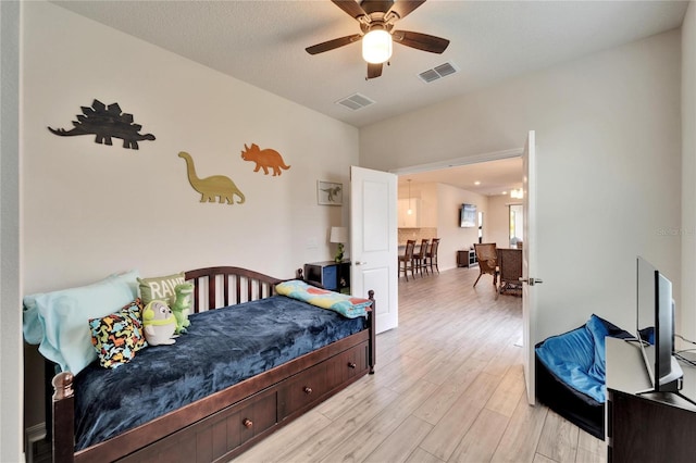 bedroom featuring light hardwood / wood-style floors and ceiling fan