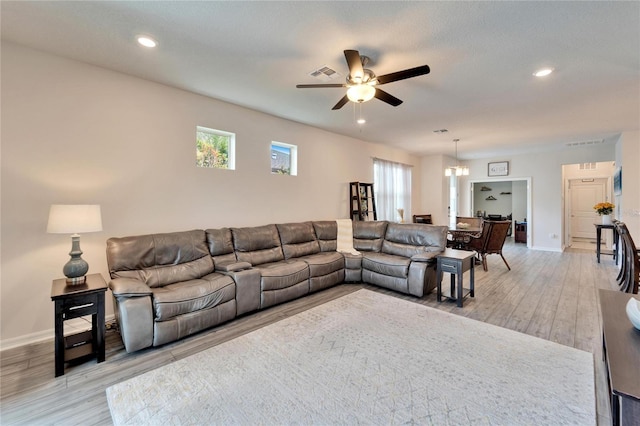 living room with light hardwood / wood-style flooring and ceiling fan