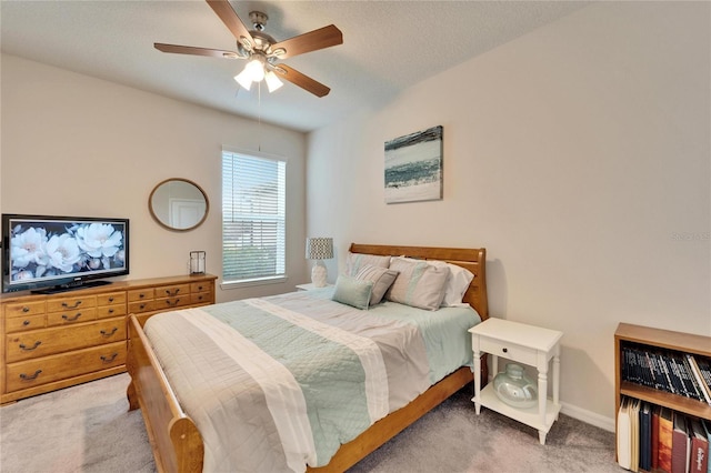 bedroom featuring light carpet, ceiling fan, and baseboards