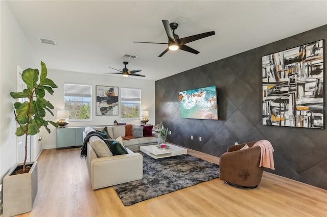 living room with hardwood / wood-style flooring and ceiling fan