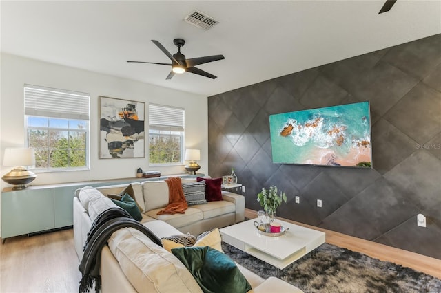 living room with hardwood / wood-style flooring and ceiling fan