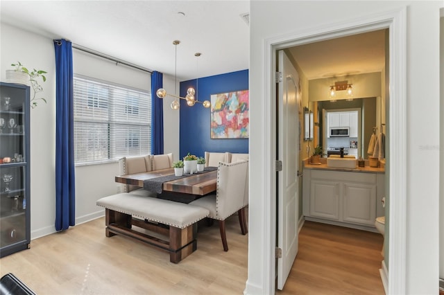 dining space with breakfast area and light hardwood / wood-style flooring