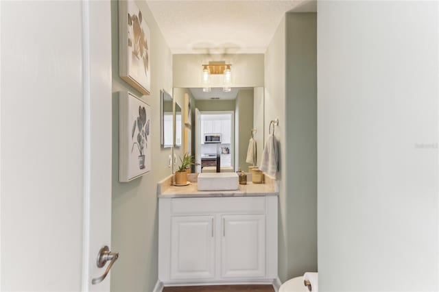 bathroom with vanity and a textured ceiling